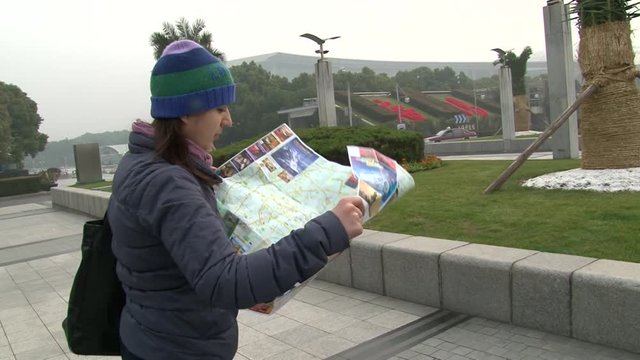 Tourist girl in Shanghai China, Look on map, medium shoot