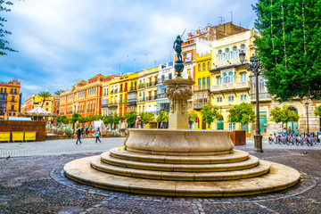 Naklejka premium view of a fountain situated ion the plaza de san francisco in front of the town hall in sevilla