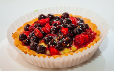 Dessert with wild berries. Sweet tart with wild strawberry, blueberry and red currant.