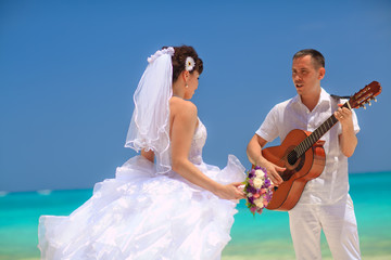 Groom playing the guitar for the bride