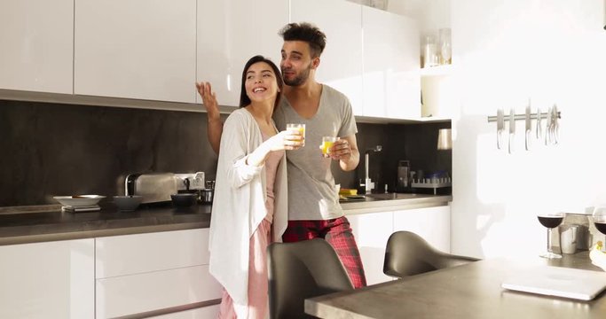 Young Mixed Race Couple Talking Morning Sunlight, Happy Hispanic Man Asian Woman Together In Kitchen Breakfast Slow Motion