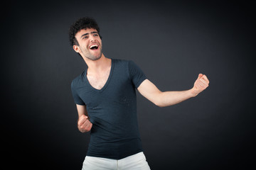 Handsome man doing different expressions in different sets of clothes: arms raised