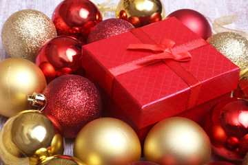 Christmas gift box with red and gold balls