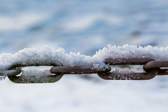 Iron chain covered with snow crystals