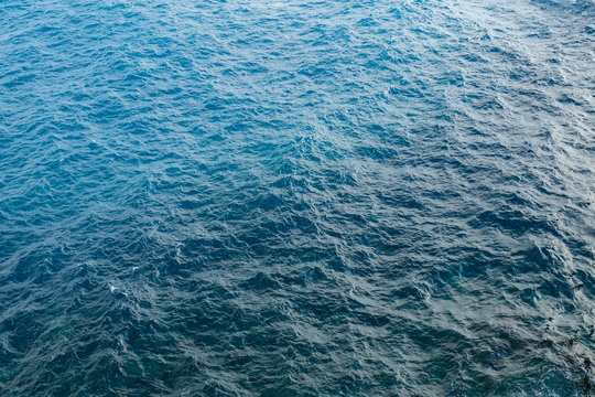 blue colored water surface with light waves on the open sea