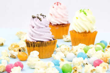 Pink frosted cupcakes on light blue background