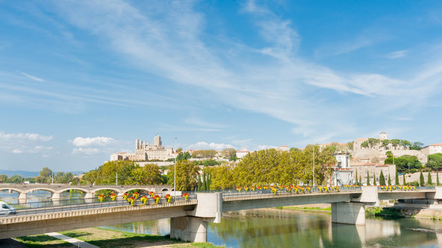 Beziers view acrosstwo bridges over Orb River to city and Cathedral