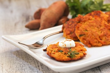 Sweet Potato Latkes served with sour cream dollop, selective focus