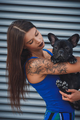 Portrait of black bulldog and its owner