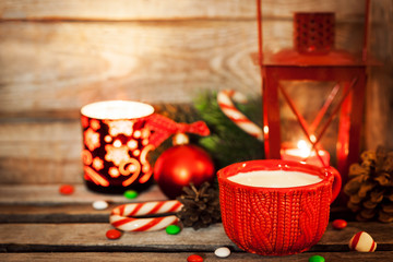 Christmas time red cup of milk and latern with candle light, hol