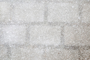Looks like blurry ice on the pavement surface. Slippery walkway. Background.