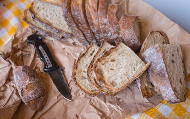 bread on a wooden board and   knife