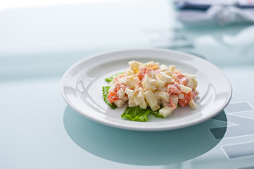Fresh vegetable salad with corn, pepper, crab, cucumber, eggs and mayonnaise