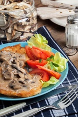 Crispy fried homemade potato pancakes with mushroom sauce.