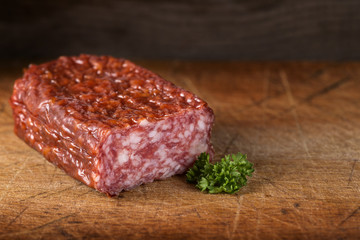 Italian salami on wood with parsley