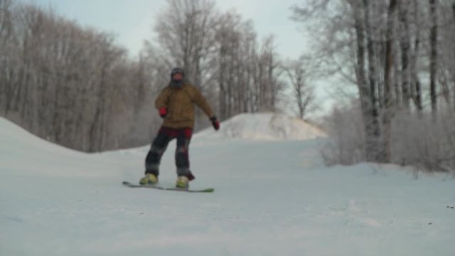 snowboarder riding in the mountains on a snowboard