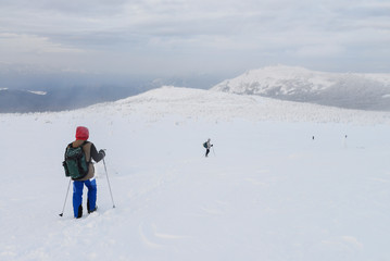 Fototapeta na wymiar Group of hikers in winter mountains, Russia, Ural.