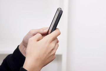 closeup of the hands of the child with the phone mobile