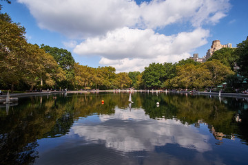 NEW YORK CITY - OCTOBER 03, 2016: People playing with small models of sailboats on Conservatory Water in Central Park