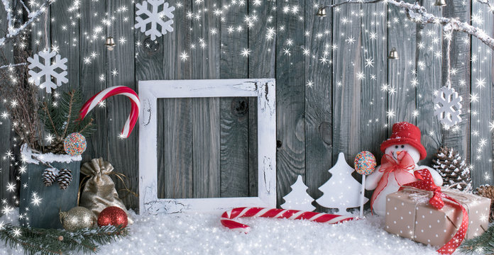 Christmas interior with snowman, photo frame, decorative branches, gifts