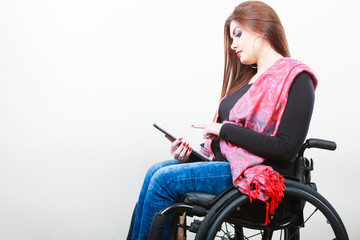 Young disabled lady with tablet.