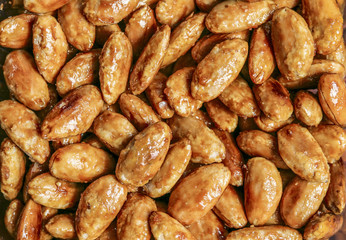 Caramelized peanuts as background close up.