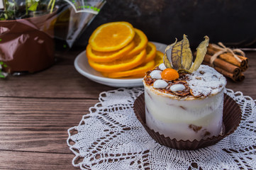 Cake with cream on a dark wood background.