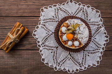 Cake with cream on a dark wood background. Top view. Close-up