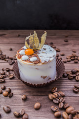 Cake with cream on a dark wood background. Close-up