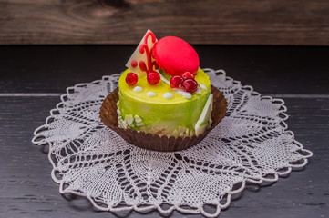 Cake with cream on a dark wood background. Top view. Close-up