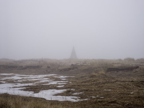 Fog in rural landscape against conical structure