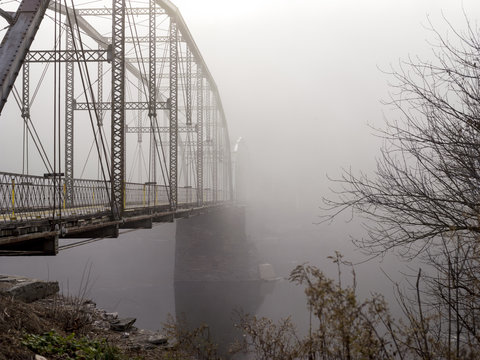 Bridge spanning water in mist