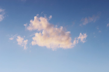 white clouds against the blue sky on a sunny winter day in the evening.