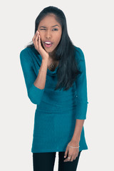 Fototapeta premium Beautiful woman doing different expressions in different sets of clothes: toothache