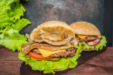 Great Hamburger and french fries on a wooden table in rustic style