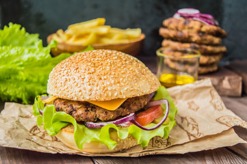 Great Hamburger and french fries on a wooden table in rustic style. Close-up