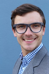 Portrait of handsome cheerful young smiling man in glasses