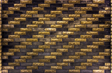 brick wall of black and yellow bricks