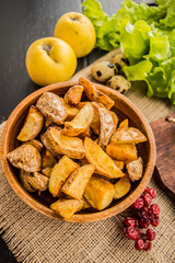 Baked potato in village. On a black background. Top view. Close-up