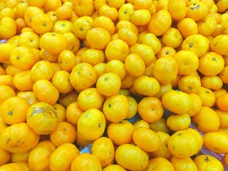 Top view of orange fruits background at market