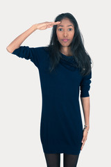 Beautiful woman doing different expressions in different sets of clothes: at attention