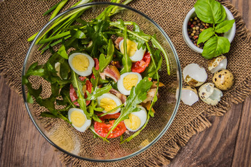 Salad with bacon and arugula. Wooden rustic background. top view
