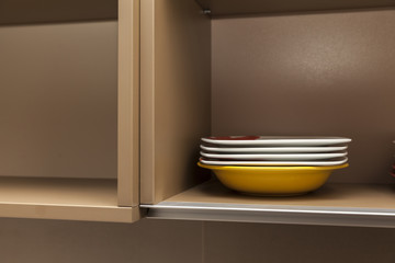 Fototapeta na wymiar plates in the kitchen shelf