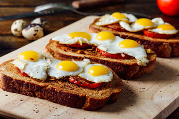 Toasts with Fried Eggs on Cutting Board