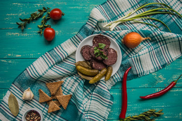 Homemade blood sausage with offal on a turquoise wooden background. top view. Close-up