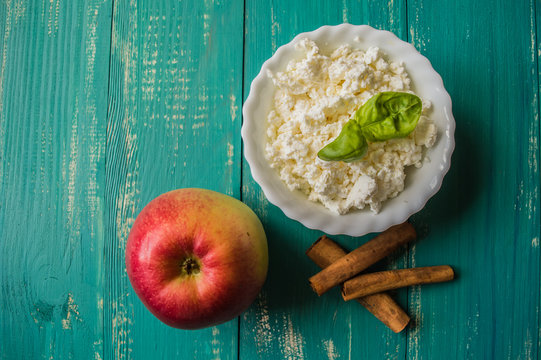 Gentle dessert with cottage cheese and ripe fresh fruit on wooden turquoise background. top view. Close-up