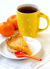 Lemon and orange tart with tea and tangerines on white background