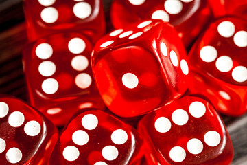 risk concept playing dice at dark wooden background top view