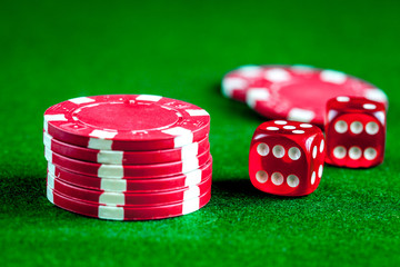 stack of chips play poker on green background close up