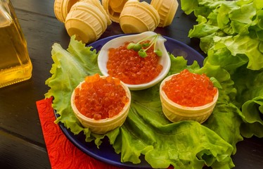 Salmon red caviar and lettuce leaves